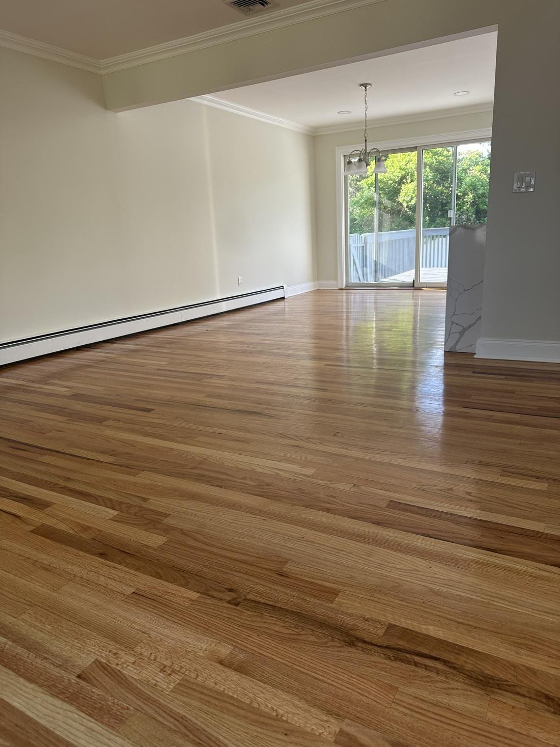 Living room with refinished oak floor, walls shown in the selected paint color