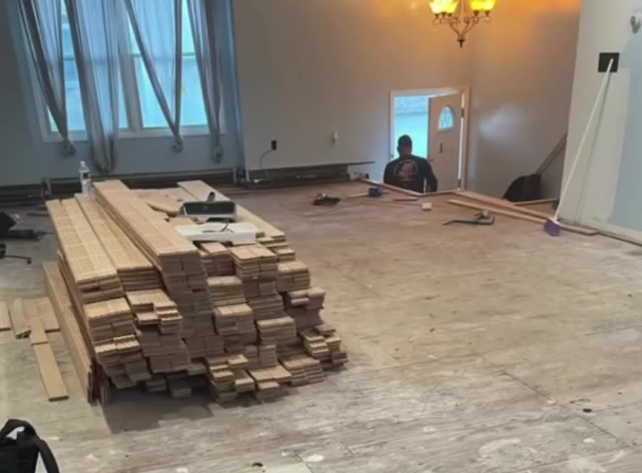 Bundles of new hardwood stacked on a prepared subfloor