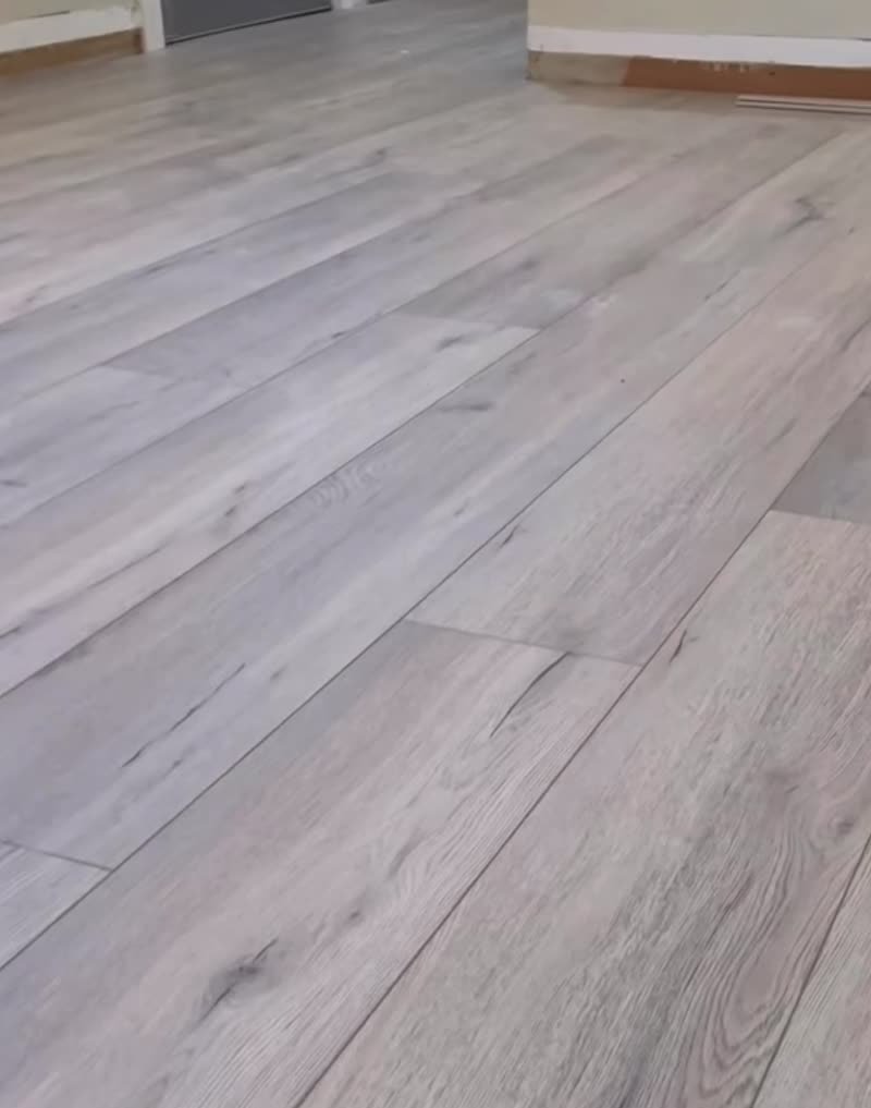 Gray luxury vinyl plank installed in an empty room